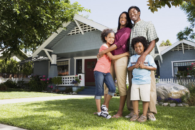 Photo of Black family in front of their home