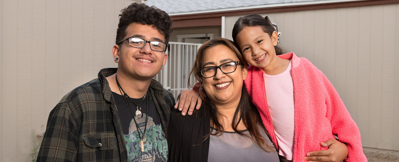 Susie Zavala with her teenage son Angel and 5-year-old daughter Jayla in front of their home in Mesa, Arizona.