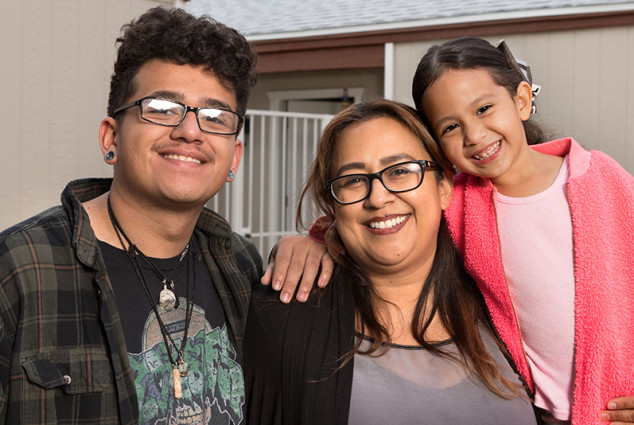 Susie Zavala with her teenage son Angel and 5-year-old daughter Jayla in front of their home in Mesa, Arizona.