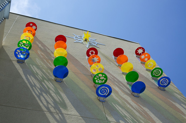 Colored plastic cutouts are an imaginative design element at the complex, creating rainbows when the light shines through.